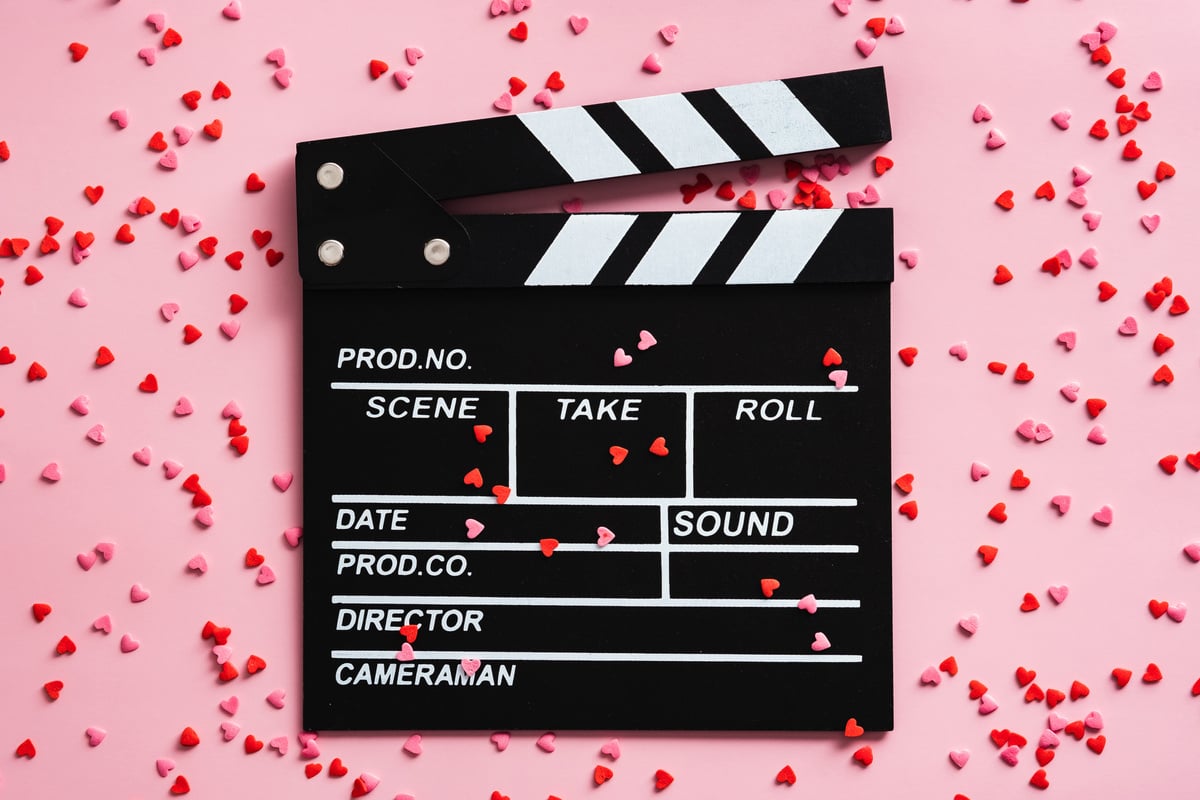 Movie Clapper Board and Confetti on Pink Background. Romantic Movie, Love Concept.